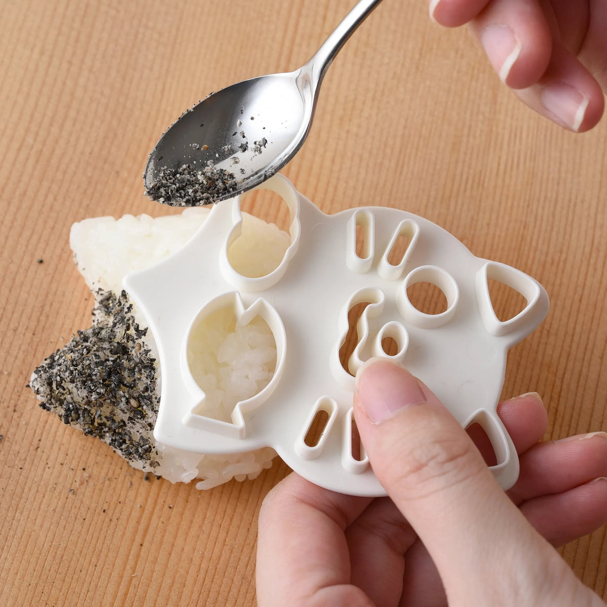 Neko Kao Onigiri Set – pink cat-shaped rice mold, nori cutter, and face stamp laid out on white background