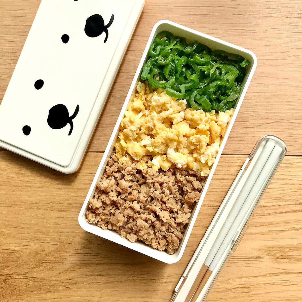 GEL-COOma Bento Box filled with soboro, scrambled egg, and green pepper lunch