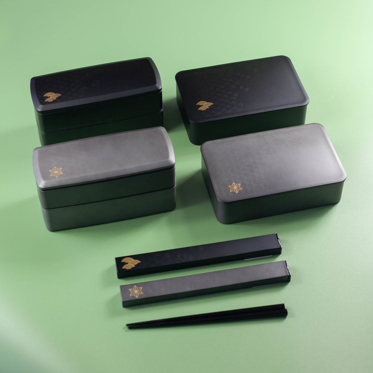 Wamon Bento Box 800mL – black seigaiha and grey maple leaf variants with matching chopstick cases on green background