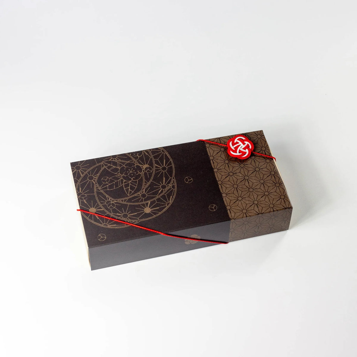 Wafu Japanese Green Tea Gift Set – open dark brown gift box with three colorful floral tea pouches inside: yellow floral sencha, white geometric hojicha, and green floral matcha green tea, on white background