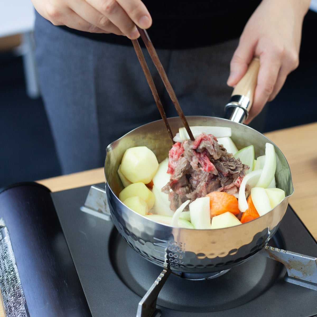 YukiHira Nabe Pot 16cm – stainless steel saucepan with honeycomb hammered interior and natural wood handle, angled top view on white background
