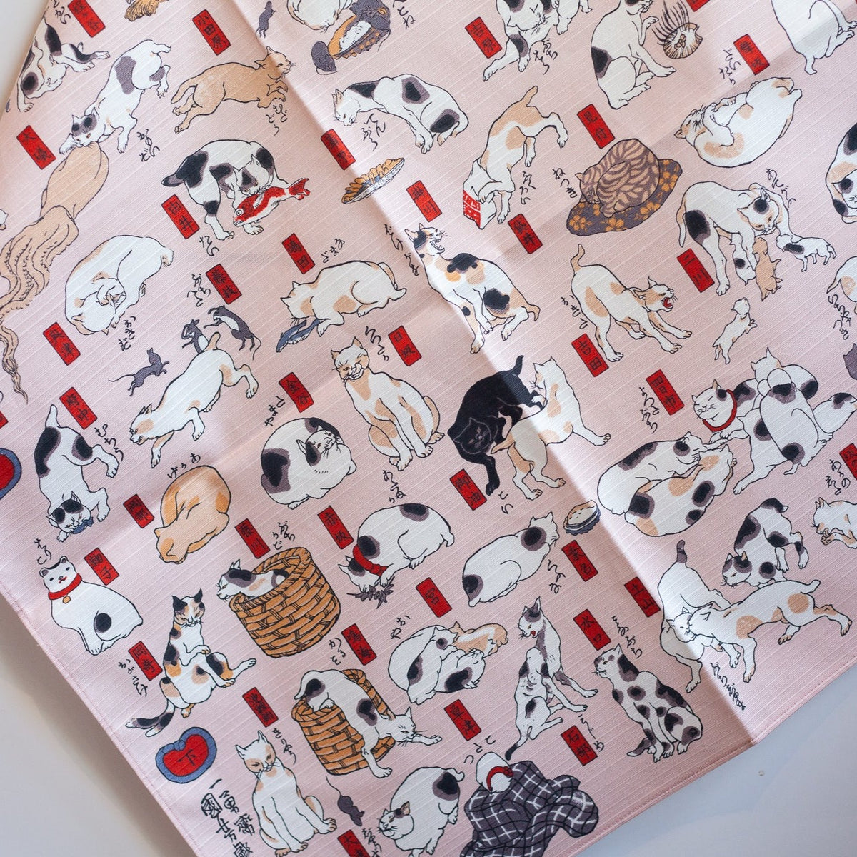 Sumidagawa Furoshiki 48cm Tokaido Cats – Japanese wrapping cloth featuring dozens of cats in various poses inspired by Ukiyo-e artist Kuniyoshi's "Cats suggested as the Fifty-three Stations of the Tokaido", pink background, made in Japan