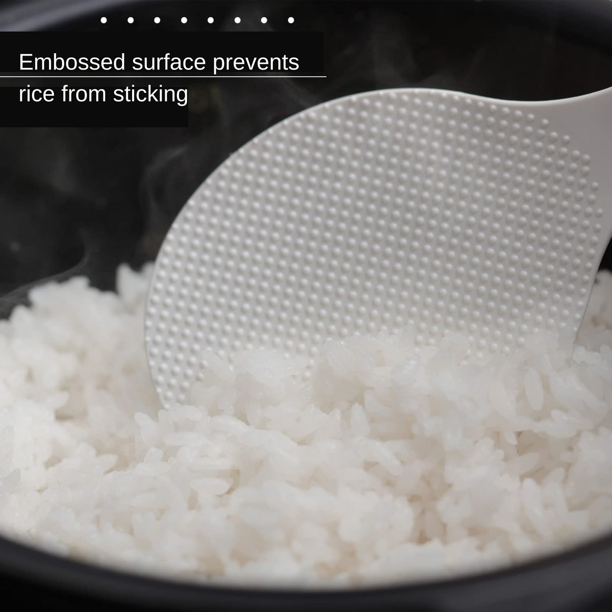 Close-up of Marna Standing Rice Paddle scooping rice from rice cooker – embossed surface prevents rice from sticking