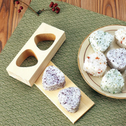 Hinoki Onigiri Mold – Japanese cypress wood rice ball mold with two triangle-shaped cavities for making perfectly shaped onigiri, shown with freshly made rice balls, made in Japan