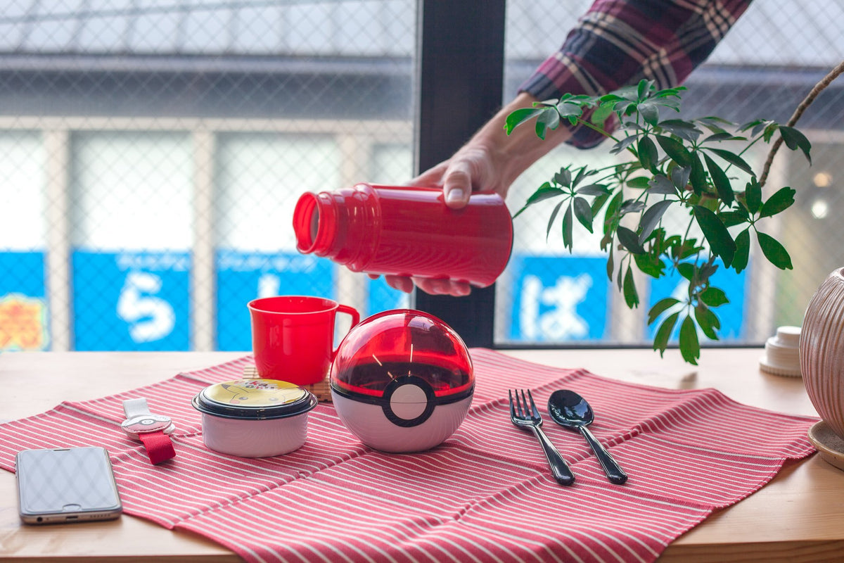 Pokeball Bento Box, small two-tier lunch box shaped like a Pokeball with lunch band
