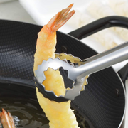 Stainless steel tempura tongs with circular serrated tips gripping a golden fried shrimp tempura over hot oil in black frying pan