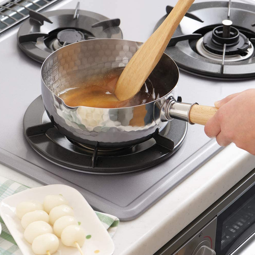YukiHira Nabe Pot 18cm – polished stainless steel hammered saucepan with wood handle on white kitchen countertop, lifestyle shot