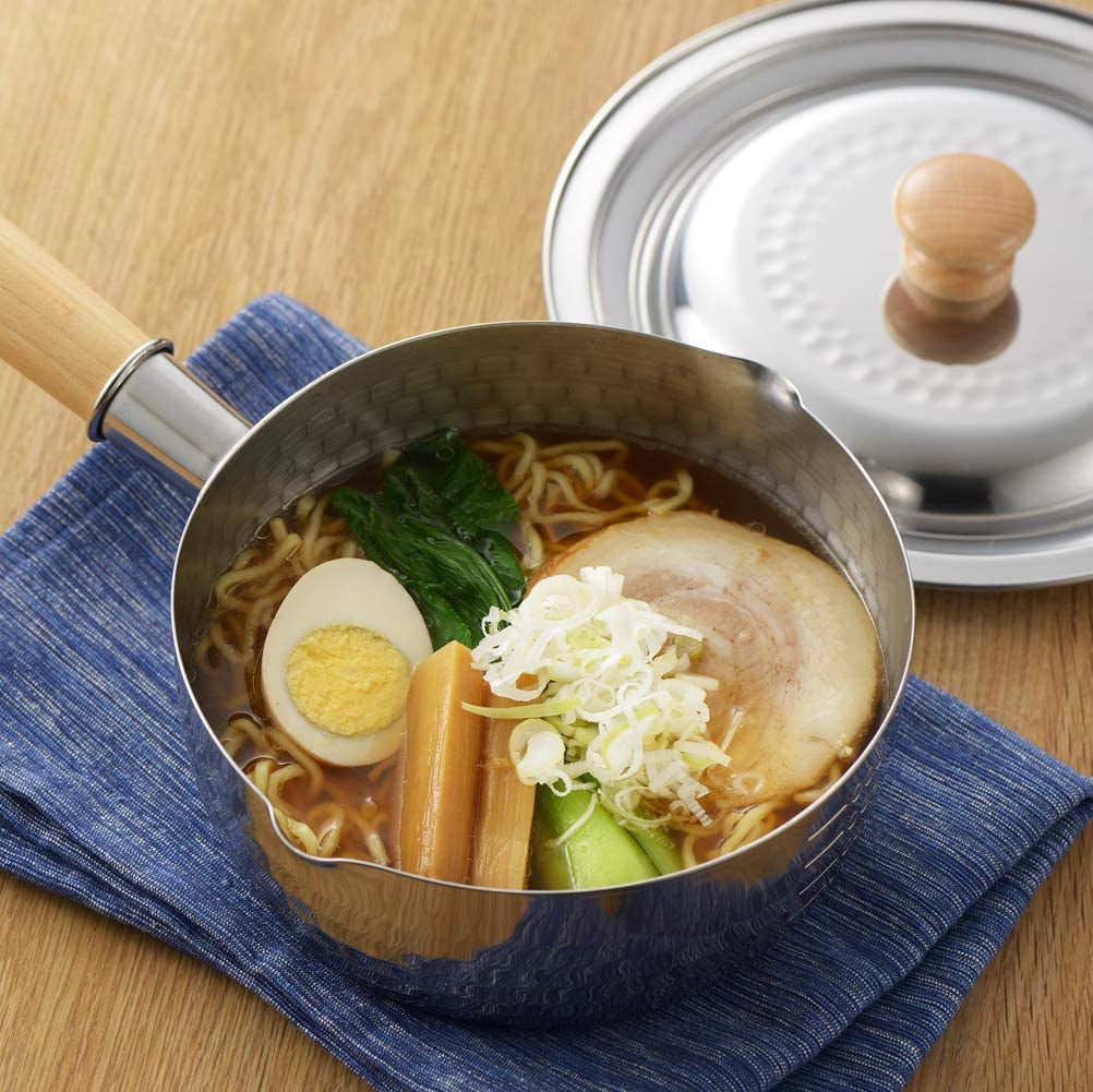 YukiHira Nabe Pot 16cm served as ramen bowl with chashu, boiled egg, bok choy and green onions on blue linen placemat, with hammered stainless lid beside it