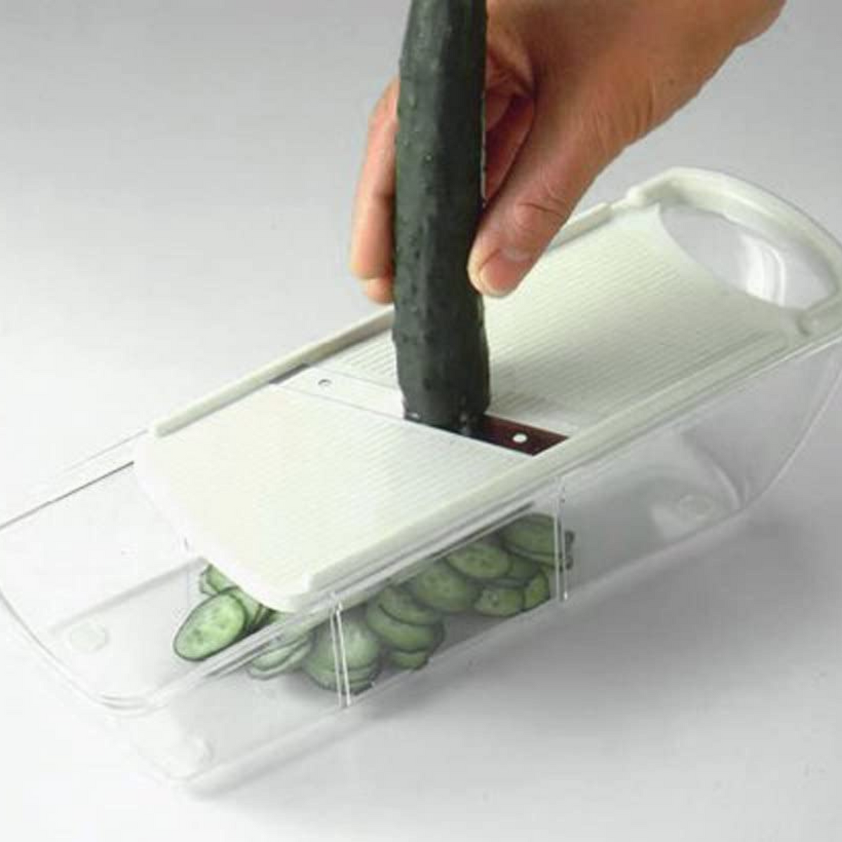 Mandoline Slicer Set with 4 interchangeable blades, peeler, and storage tray