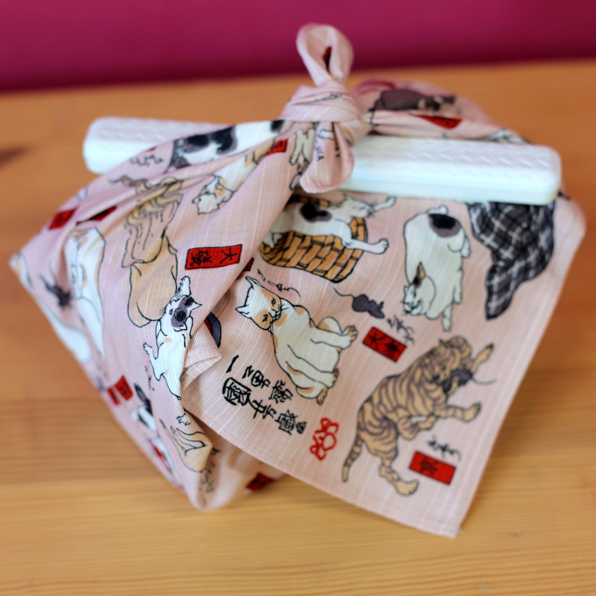 Sumidagawa Furoshiki 48cm Tokaido Cats – Japanese wrapping cloth featuring dozens of cats in various poses inspired by Ukiyo-e artist Kuniyoshi's "Cats suggested as the Fifty-three Stations of the Tokaido", pink background, made in Japan