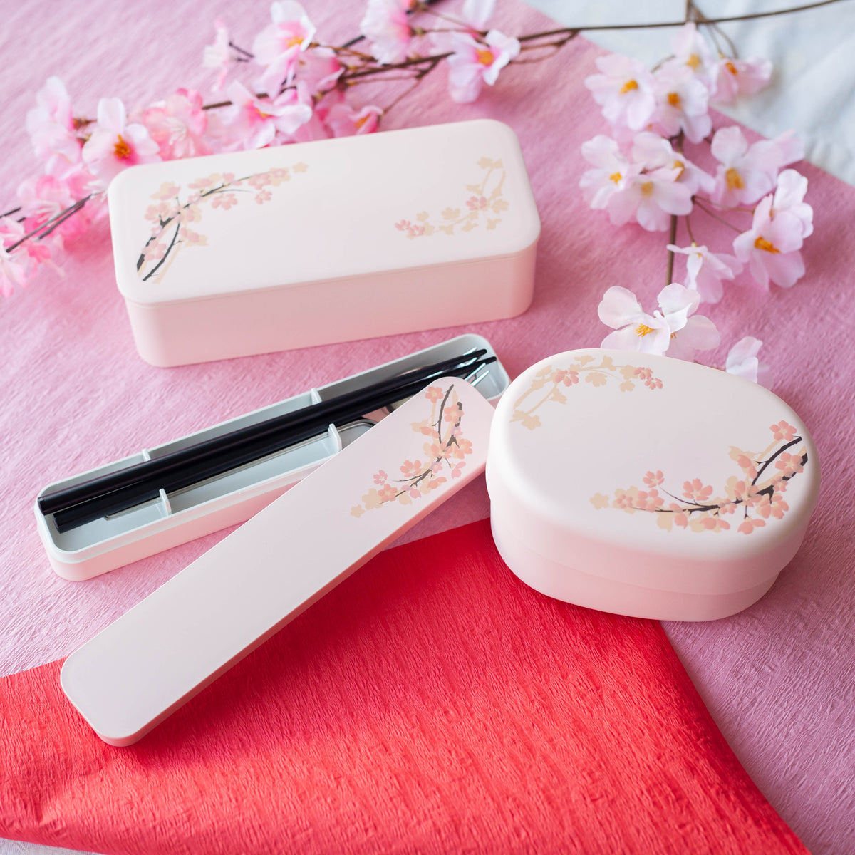 Sakura Cutlery Set pink case closed, angled view showing cherry blossom branch design on soft pink background