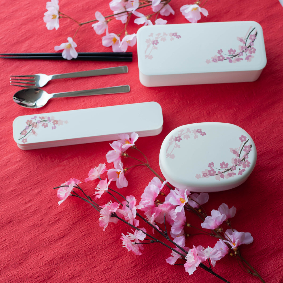 Sakura Cutlery Set white case closed, angled view showing pink cherry blossom branch design on white background